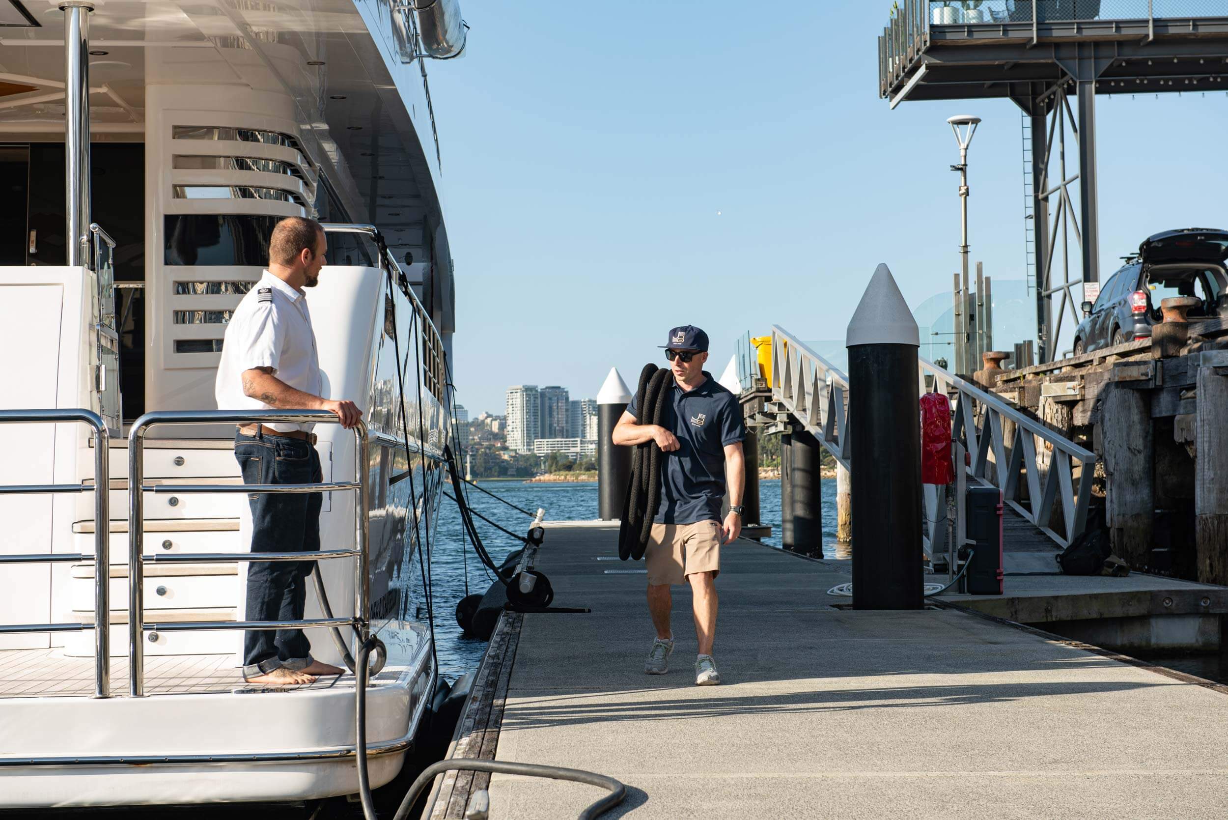 Marina attendant greets yacht captain at Jones Bay Superyacht Marina.